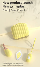 Yellow case with vibrator, remote control on a light background